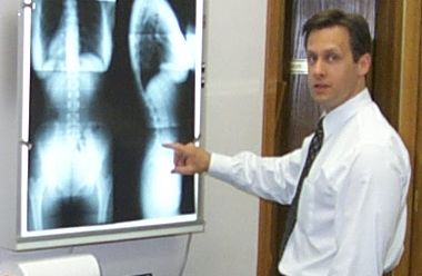 Robert Katona viewing X-ray of patient in Chiropractic Office
